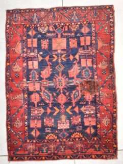 Condition detail of Hamadan Persian rug showing wear and patch repair